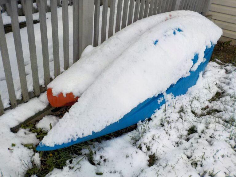 snow-covered kayaks